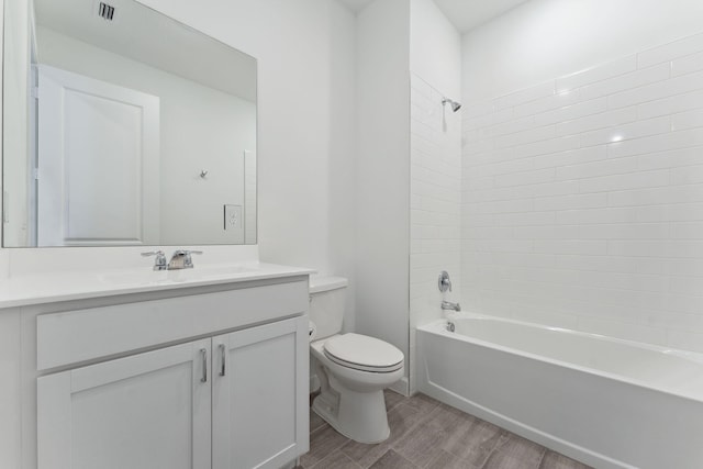 full bathroom with shower / bathing tub combination, vanity, hardwood / wood-style flooring, and toilet