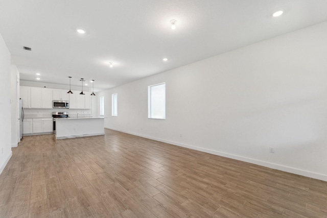 unfurnished living room featuring light hardwood / wood-style flooring