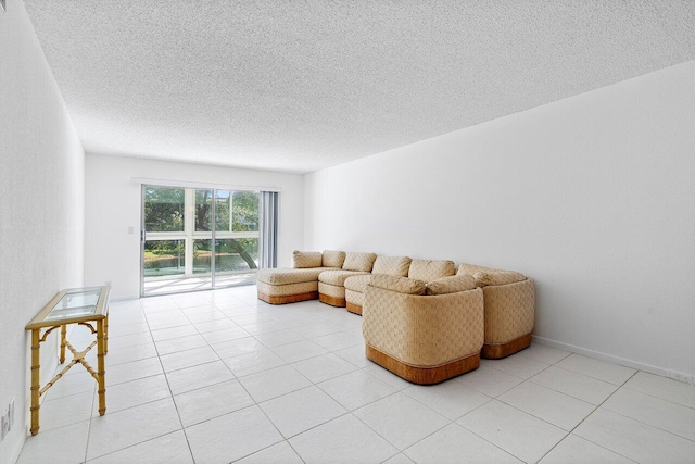 living room featuring a textured ceiling and light tile patterned flooring