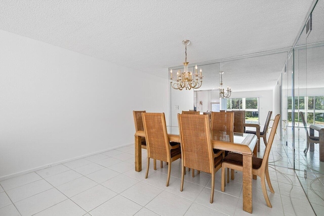 dining space featuring light tile patterned floors, a textured ceiling, and an inviting chandelier