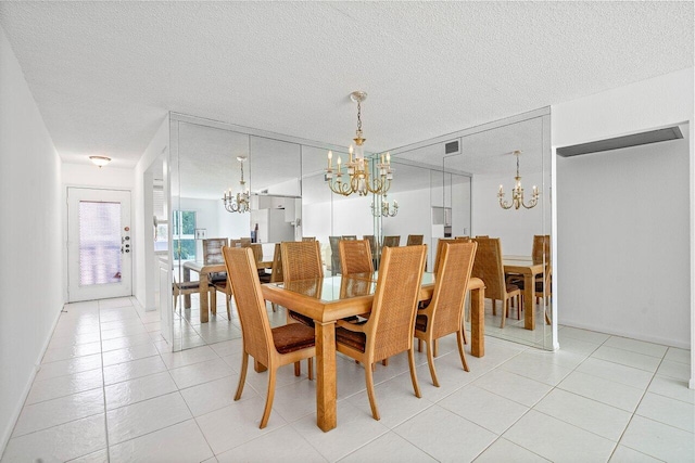 dining room with a textured ceiling and light tile patterned floors