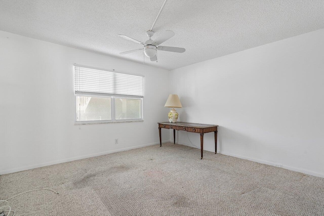 spare room with carpet, a textured ceiling, and ceiling fan