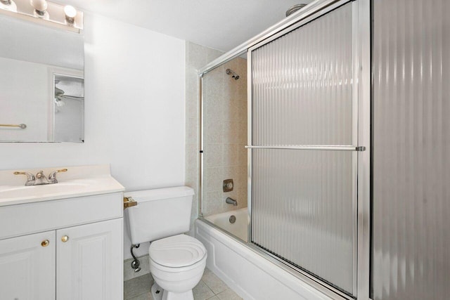 full bathroom featuring vanity, toilet, tile patterned floors, and shower / bath combination with glass door