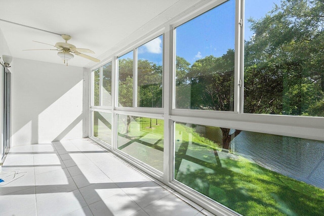 unfurnished sunroom with ceiling fan