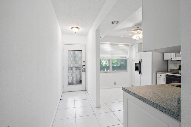 kitchen featuring black electric range, white fridge with ice dispenser, a textured ceiling, white cabinetry, and ceiling fan