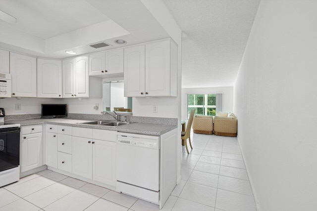 kitchen with sink, light tile patterned floors, white cabinets, a textured ceiling, and white appliances