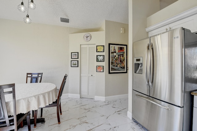 dining space with a textured ceiling