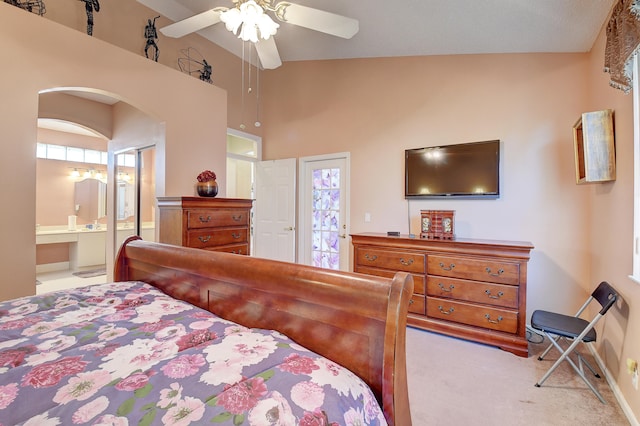 bedroom featuring ensuite bathroom, ceiling fan, multiple windows, and light carpet