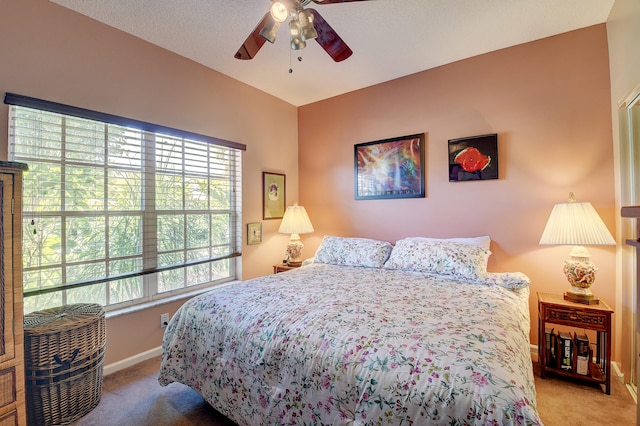 bedroom with a textured ceiling, ceiling fan, and carpet floors