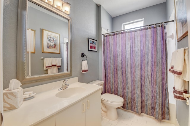 full bathroom with toilet, shower / bath combo, vanity, and tile patterned floors