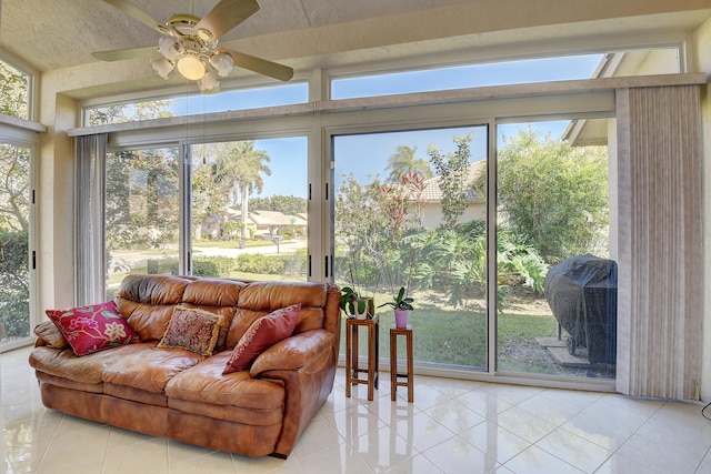 sunroom featuring ceiling fan, plenty of natural light, and a skylight