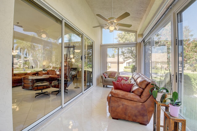 sunroom / solarium featuring lofted ceiling and ceiling fan