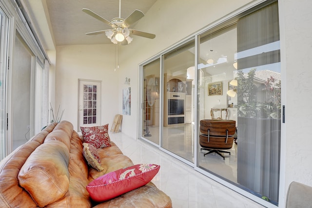 sunroom with lofted ceiling and ceiling fan