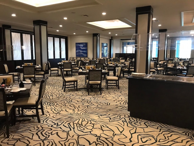 dining room with light carpet and ornate columns