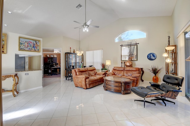 tiled living room featuring ceiling fan with notable chandelier and high vaulted ceiling