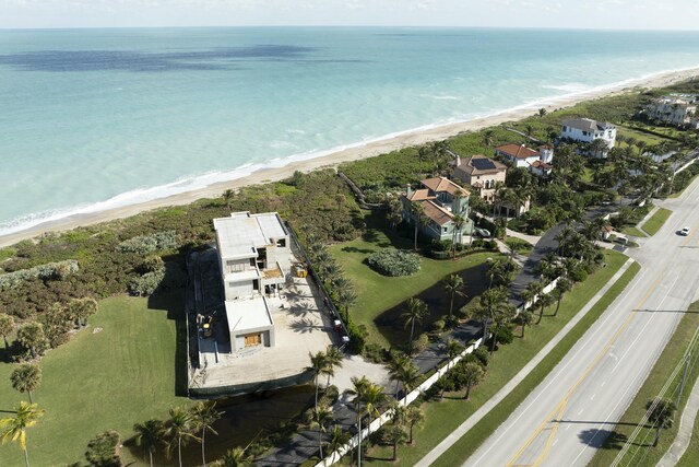 drone / aerial view with a water view and a beach view