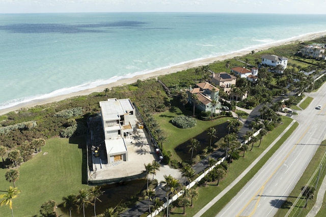 birds eye view of property with a view of the beach and a water view