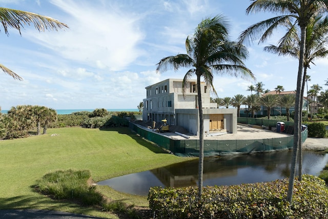 view of community featuring a yard and a water view