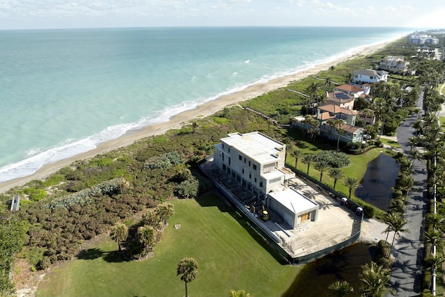 drone / aerial view featuring a water view and a beach view