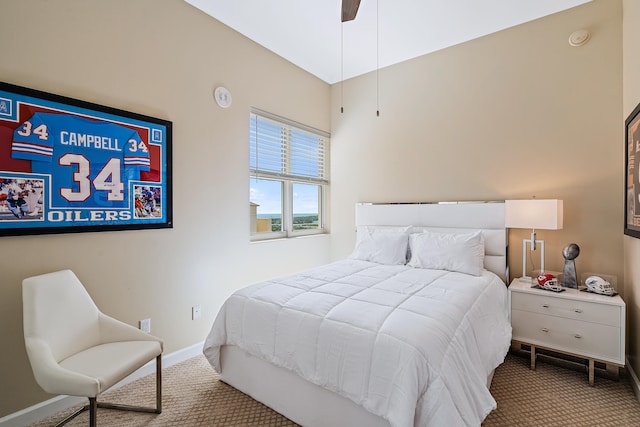 bedroom featuring ceiling fan and carpet