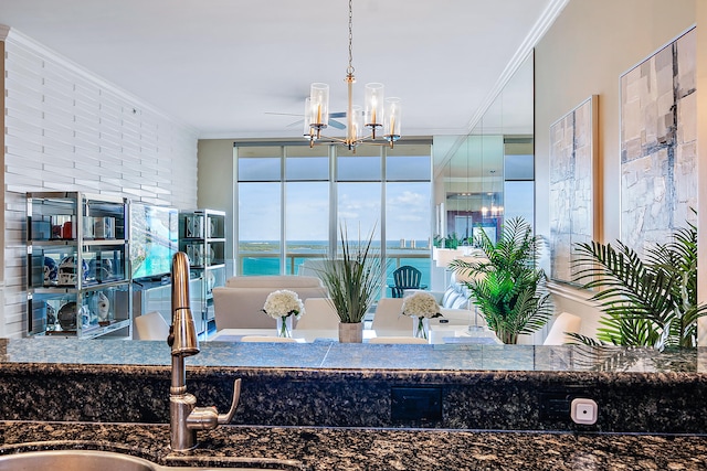 bathroom with brick wall, sink, a water view, a chandelier, and crown molding