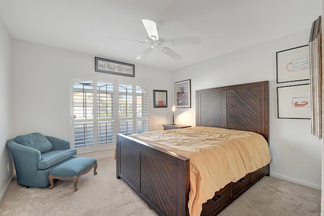 bedroom featuring a ceiling fan, light carpet, and baseboards