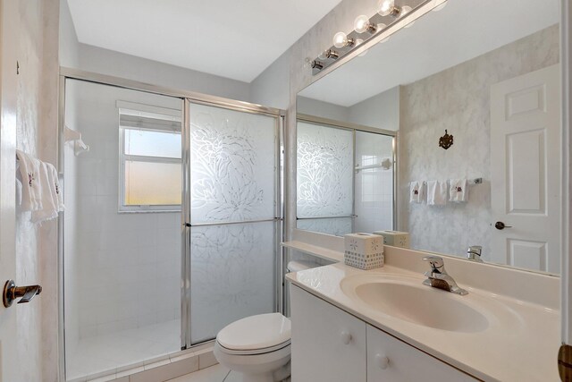 full bathroom featuring toilet, a shower stall, tile patterned flooring, and vanity