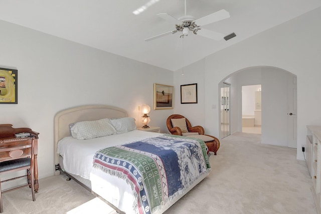 carpeted bedroom with connected bathroom, ceiling fan, and vaulted ceiling