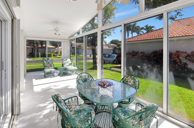 sunroom / solarium featuring lofted ceiling and a ceiling fan