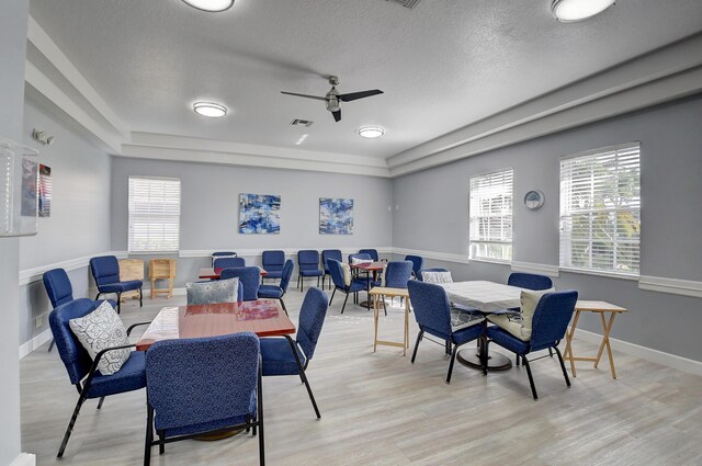 recreation room featuring light wood finished floors, baseboards, and visible vents