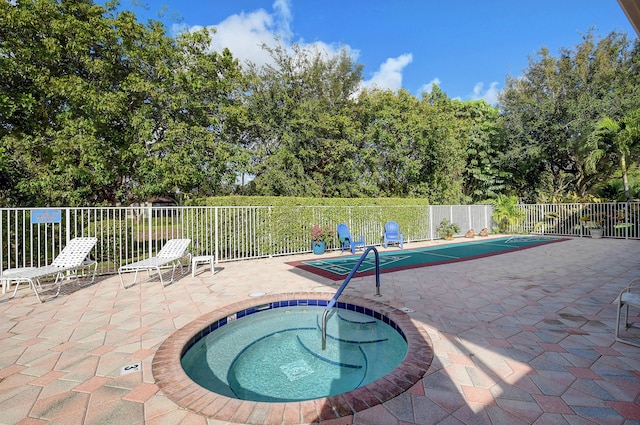 view of pool with a patio area and a hot tub