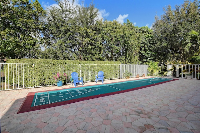 surrounding community featuring fence and shuffleboard