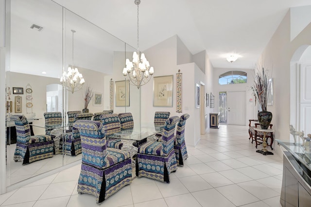 dining space with a chandelier, arched walkways, light tile patterned flooring, and visible vents