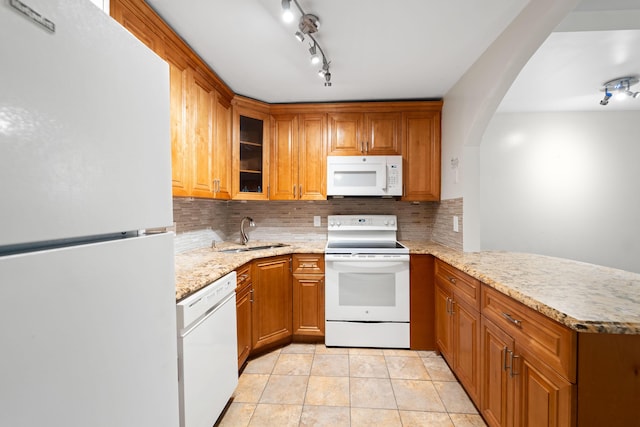 kitchen with white appliances, sink, decorative backsplash, light tile patterned floors, and kitchen peninsula