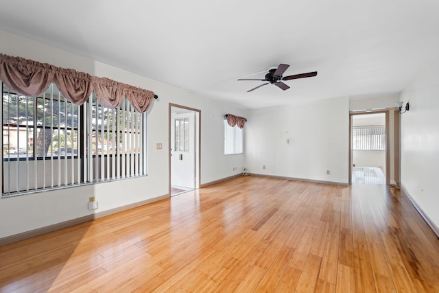 unfurnished room with ceiling fan, light hardwood / wood-style flooring, and a healthy amount of sunlight