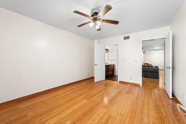 unfurnished bedroom featuring connected bathroom, ceiling fan, and light hardwood / wood-style floors