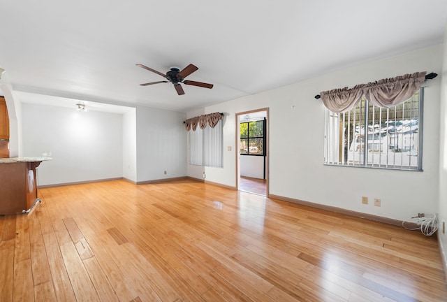 unfurnished living room featuring light hardwood / wood-style floors and ceiling fan