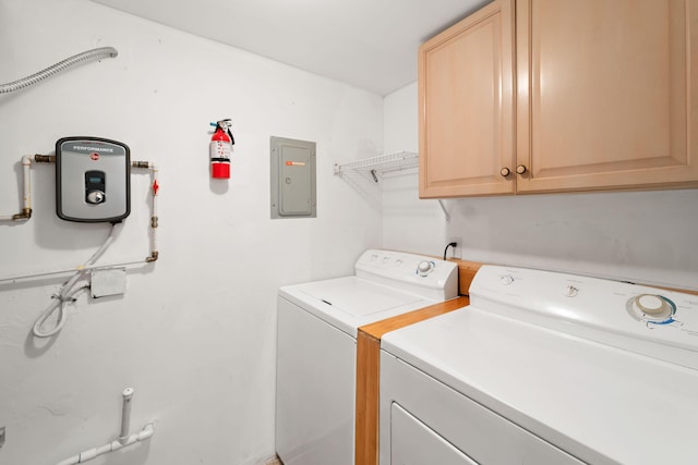 laundry area featuring electric panel, cabinets, and washer and dryer