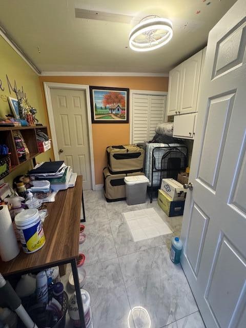 laundry area with washing machine and dryer, cabinets, and crown molding