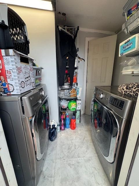 clothes washing area with washer and clothes dryer