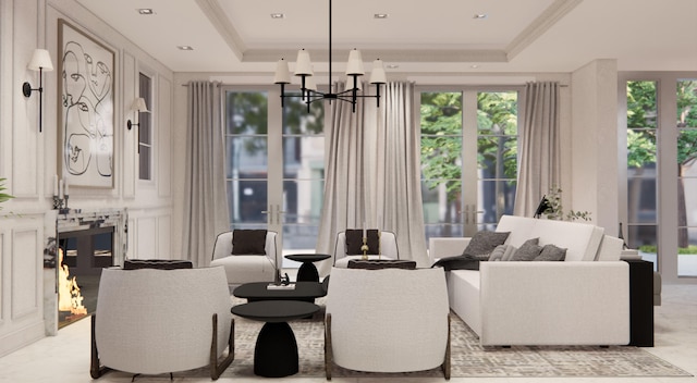 living room with a chandelier, crown molding, and a raised ceiling