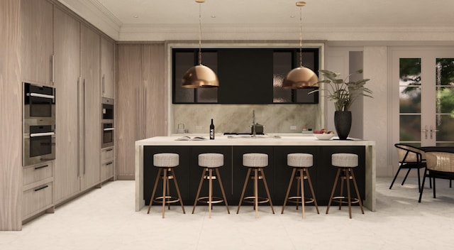 kitchen featuring an island with sink, a kitchen breakfast bar, crown molding, double oven, and decorative light fixtures