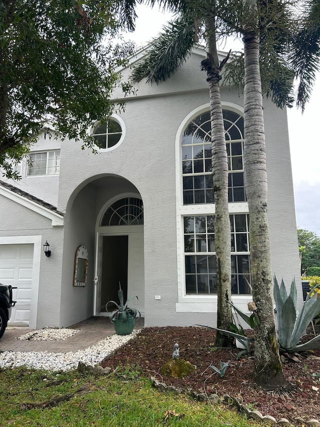 doorway to property with a garage