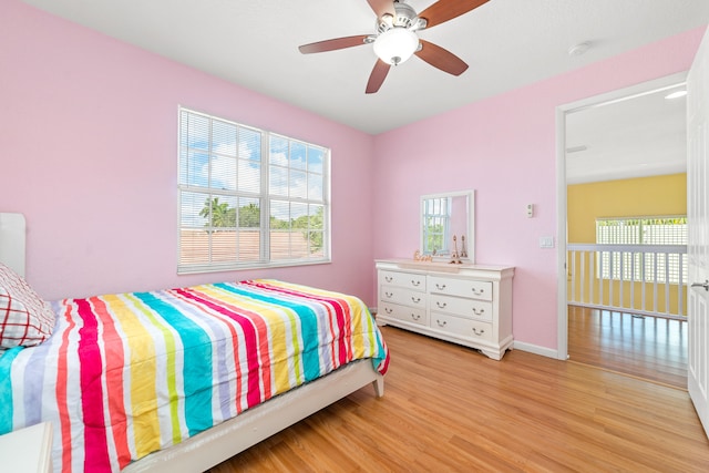 bedroom with light hardwood / wood-style floors and ceiling fan