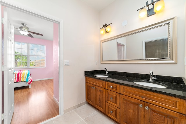 bathroom featuring hardwood / wood-style flooring, ceiling fan, and vanity