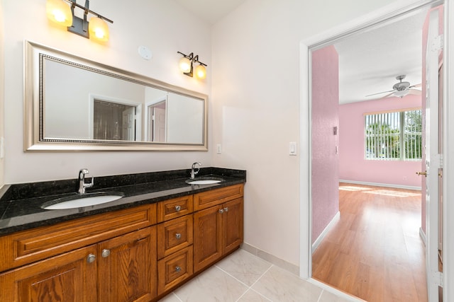 bathroom featuring vanity, hardwood / wood-style flooring, and ceiling fan