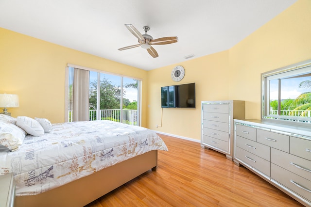 bedroom with access to outside, light hardwood / wood-style floors, and ceiling fan