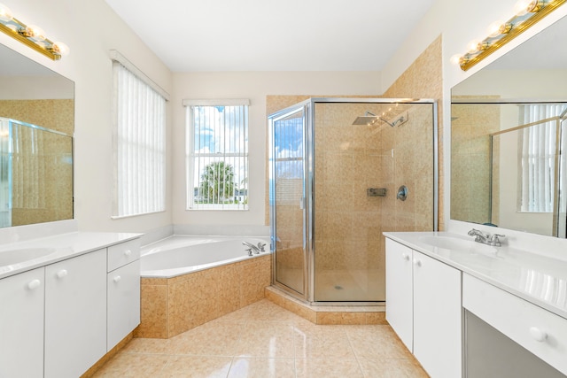 bathroom featuring independent shower and bath, vanity, and tile patterned floors