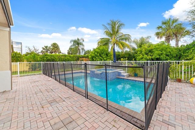 view of pool featuring a patio and an in ground hot tub