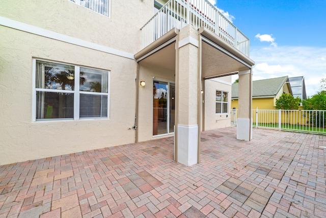 view of patio featuring a balcony